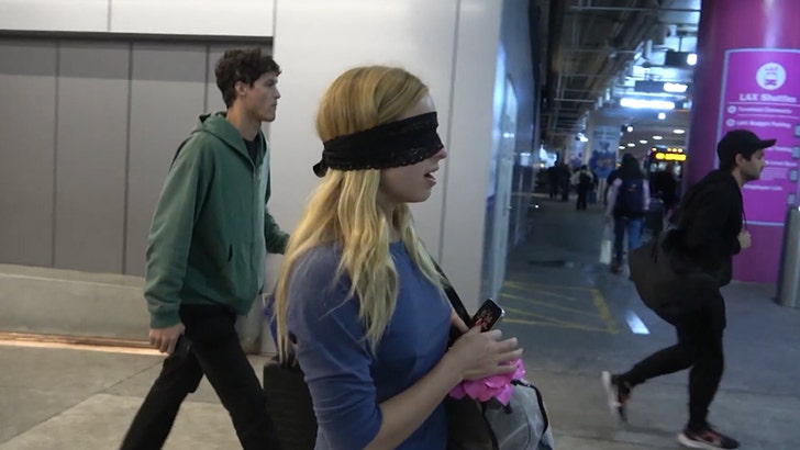 Another angle of Addison Rae at LAX with an eye mask covering her eyes. Photo: Backgrid.